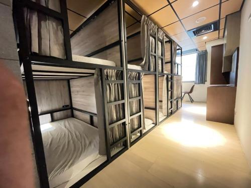 a room with four bunk beds in it at MF Hotel, penghu in Magong