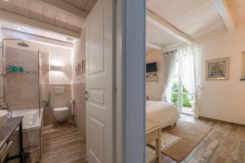 a bedroom with a bed and a shower and a bathroom at Villa Valentina in Levanto