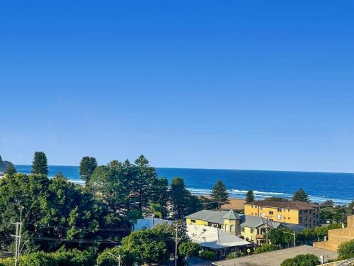 a view of a beach with houses and the ocean at Unit 32 - Avoca Palms Resort in Avoca Beach