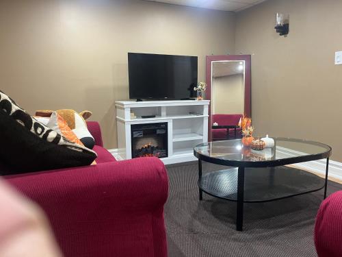 a living room with a fireplace and a tv at The Rustic Barn in Brampton