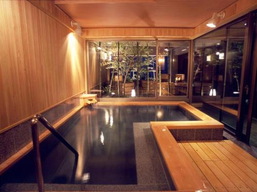 an indoor swimming pool in a building with at Kannawa Onsen Hotel Sansuikan in Beppu
