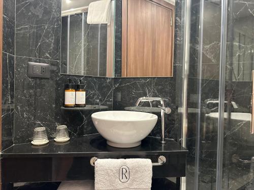 a bathroom with a sink and a mirror at Royale Sainte Hélène Boutique Hotel in Birkirkara