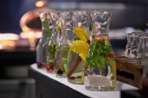 a row of glass vases filled with drinks on a table at ERIKA Boutiquehotel Kitzbühel in Kitzbühel