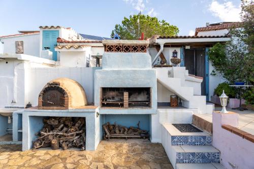 a house with a pizza oven in a courtyard at Casa Arbol in Camarles