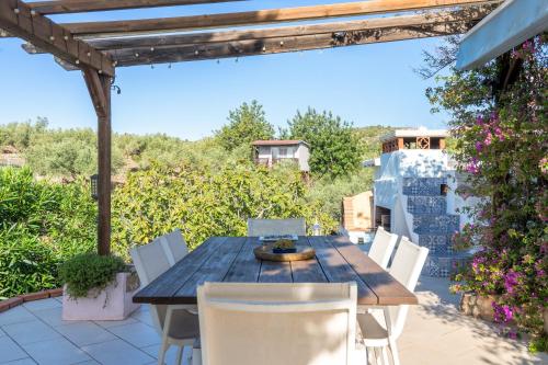 a wooden table and chairs on a patio at Casa Arbol in Camarles
