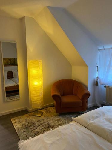 a bedroom with a chair and a bed at Ferienwohnung Villa Iris 1 in Bad Orb