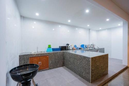 una cocina con encimera y barra en Royal beach pool villa cha-am บ้านพักชะอำ พูลวิลล่าชะอำ ใกล้ทะเล, en Cha Am