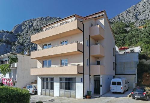 a building with cars parked in front of it at House Miho in Omiš