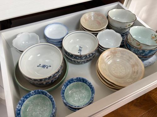a drawer filled with blue and white bowls and plates at kotobuki504condotel in Imai-kamichō