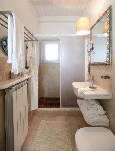a bathroom with a sink and a toilet and a mirror at Villa Valentina in Levanto
