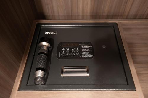a phone in a wooden box with a microphone at Dream Mansion Hotel in Taichung