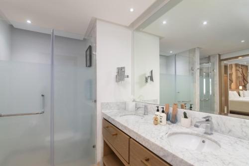 a bathroom with two sinks and a shower at Paradisus Grand Cana, All Suites - Punta Cana -All Inclusive in Punta Cana