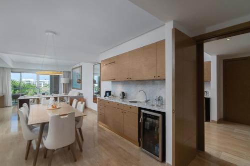 a kitchen and dining room with a table and chairs at Paradisus Grand Cana, All Suites - Punta Cana -All Inclusive in Punta Cana
