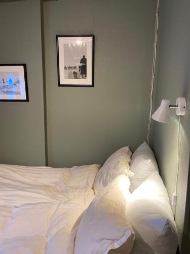 an unmade bed in a bedroom with a lamp at Ilulissat Stay - Seawatch Retreat in Ilulissat