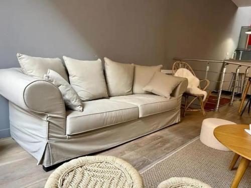 un canapé blanc dans un salon avec une table dans l'établissement Chic 4 personnes Hypercentre 5 Minutes Avenue De Champagne, à Épernay