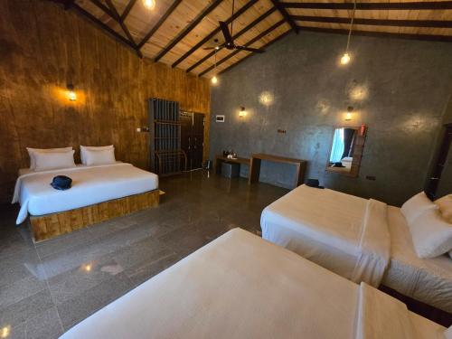a bedroom with two beds in a room at Ceylon wilpattu safaris & lodging in Wilpattu