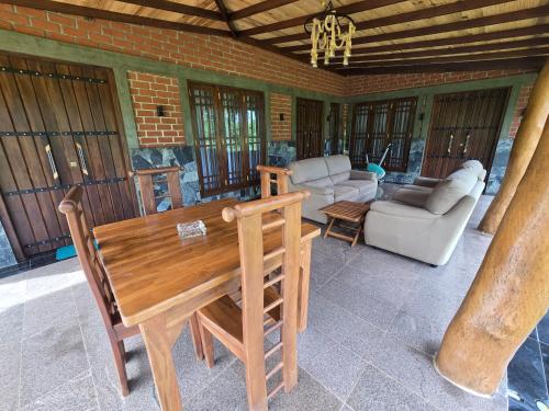 a living room with a wooden table and a couch at Ceylon wilpattu safaris & lodging in Wilpattu