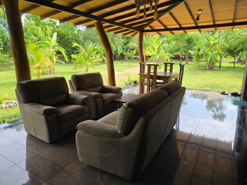 a living room with two couches and a table at Ceylon wilpattu safaris & lodging in Wilpattu