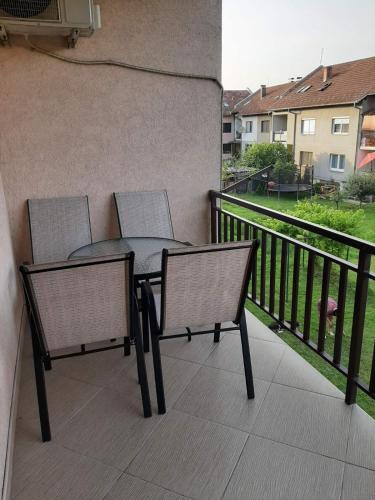 a patio with two chairs and a table on a balcony at Stan na dan Ilicka in Brčko