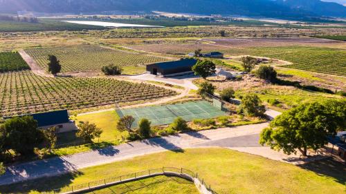 an aerial view of a tennis court in a vineyard at The Baths Natural Hot Springs in Citrusdal