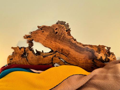 a piece of wood sitting on top of a pile of clothes at Porto Antico in Bari
