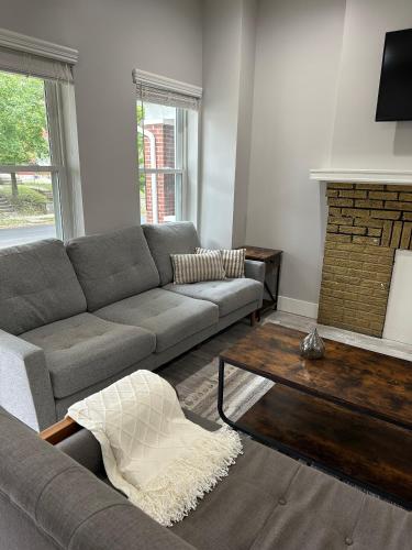 a living room with a couch and a coffee table at Charming 2BR Near Downtown & Attractions in Columbus