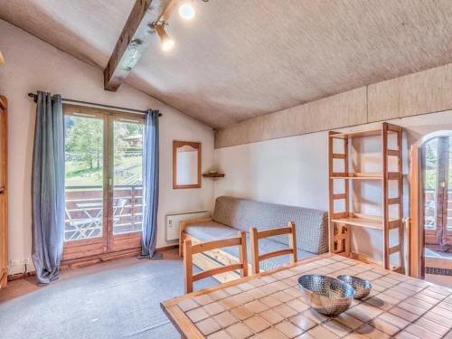 un salon avec une table et un canapé dans l'établissement Bel appartement au pied des pistes-Megeve, à Demi-Quartier