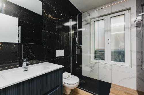a bathroom with a white sink and a toilet at Home Sofia Room 5, for Couples -By EasyLife Swiss in Lugano