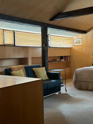 a bedroom with a bed and a couch and a table at Pokoje Gościnne WIDNOKRĄG in Sandomierz