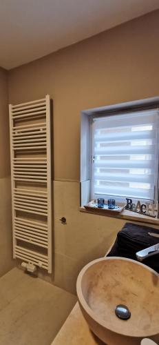 a bathroom with a sink and a window at Apartment mit Parkblick Lindau Bodensee Insel in Lindau