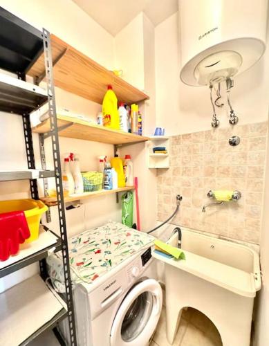 a small kitchen with a washing machine in it at Thalè - casa vacanza in Montepaone Lido