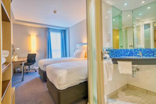 a hotel room with a bed and a bathroom at Holiday Inn Express Hull City Centre by IHG in Hull