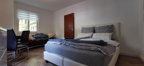 a bedroom with a bed and a desk and a television at Apartment mit Parkblick Lindau Bodensee Insel in Lindau