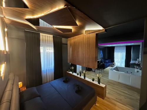 a large living room with a couch and a television at TULUM luxury suites-SKOPJE in Skopje