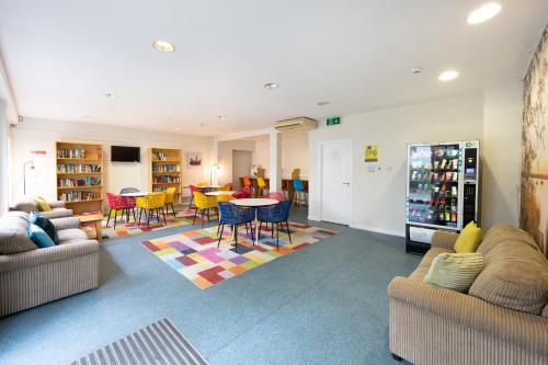 a living room with couches and a table and chairs at Victoria Lodge - UCC Summer Beds in Cork