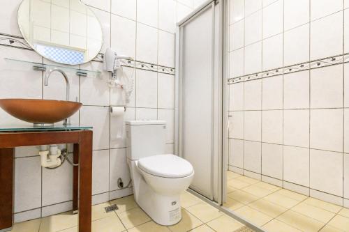 a bathroom with a toilet and a sink and a mirror at Cingjing Star Lohas Manor B&B in Renai