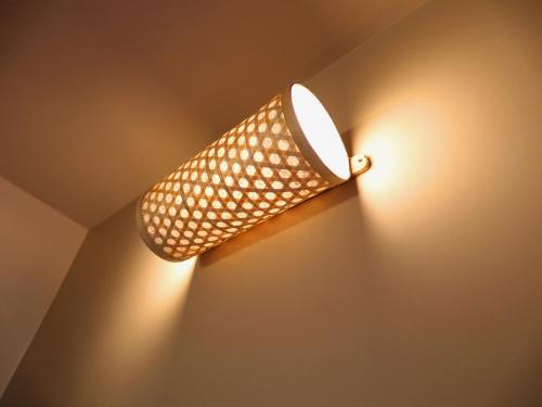 a light fixture on a ceiling with lights on it at Villa Katipadu Coorg in Srimangala