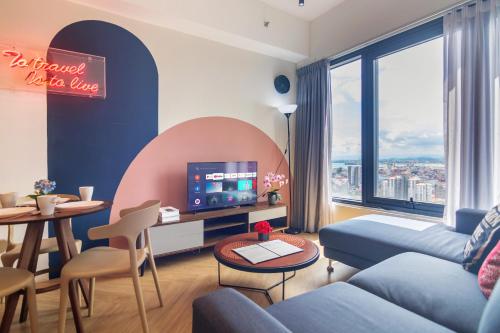 a living room with a couch and a tv at ❈ Tropicana 218 by ALV Suites ❈ in George Town