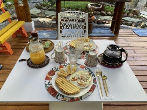a table with a plate of food and drinks on it at PaloSanto, Casa Rural in Jardin