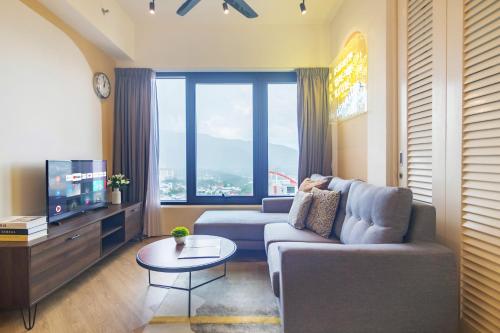 a living room with a couch and a tv at ❈ Tropicana 218 by ALV Suites ❈ in George Town