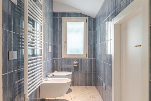 a bathroom with a toilet and a sink at Villa Celeste Argegno - Lake Como in Argegno