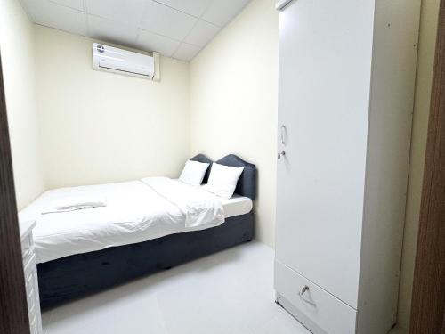 a small room with a bed and a closet at Twar Star Residence in Dubai