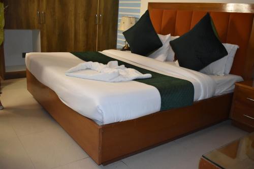 a bedroom with a bed with two towels on it at Hotel Padmini Palace in Rāni Pokhri