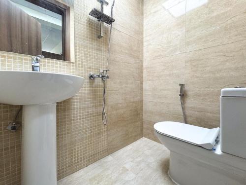 a bathroom with a sink and a toilet at Twar Star Residence in Dubai