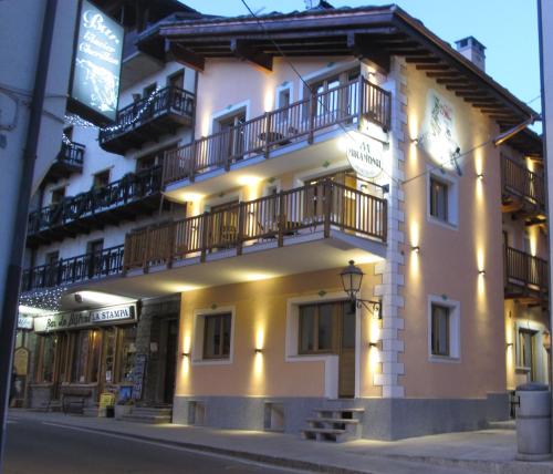 a building with a clock on the side of it at Miramonti in Valtournenche