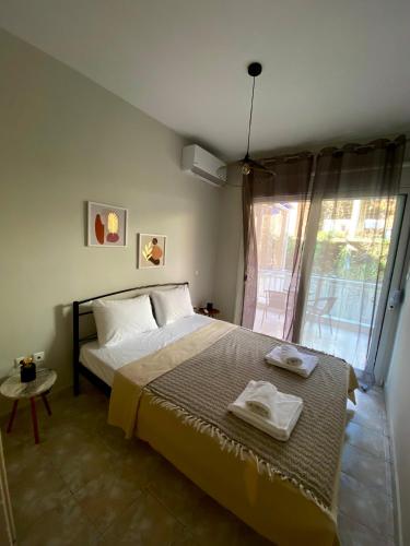 a bedroom with a bed with two towels on it at Vaso Apartment in Neos Marmaras