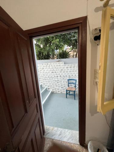 a door leading into a room with a chair at Hotel Glaros Lipsi in Lipsoi