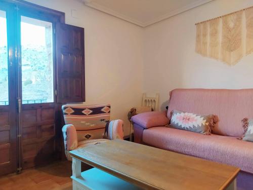a living room with a couch and a table at Mirador de Palacios- céntrico con vistas y parking cerca in Albarracín