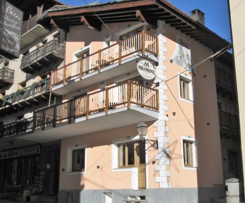 a building with a balcony on the side of it at Miramonti in Valtournenche