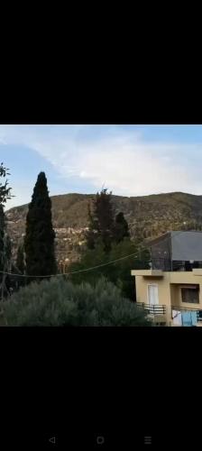 a view of a house with a mountain in the background at Barbara's K House in Káto Garoúna
